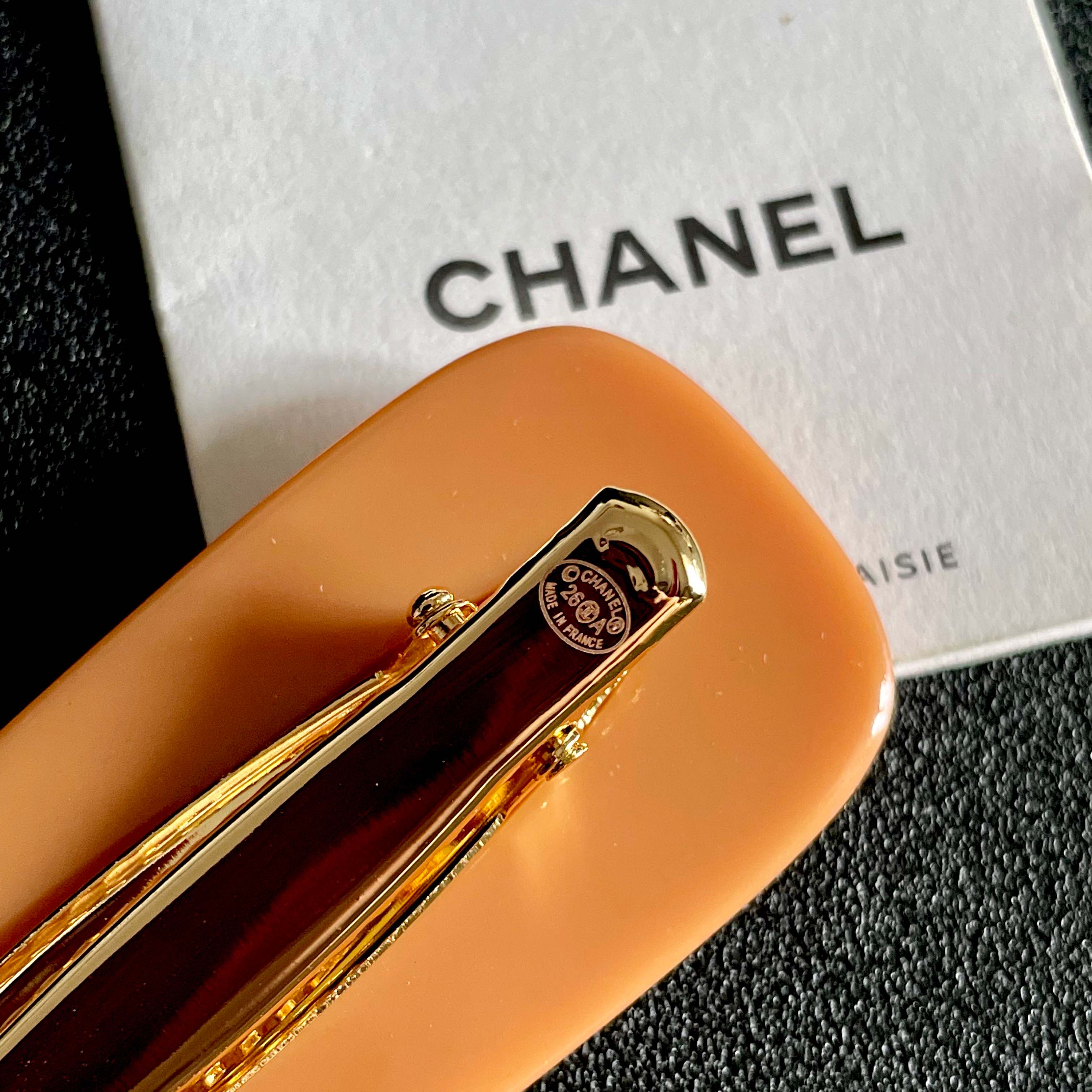 Chanel Orange Hair Clip with Black Dots
